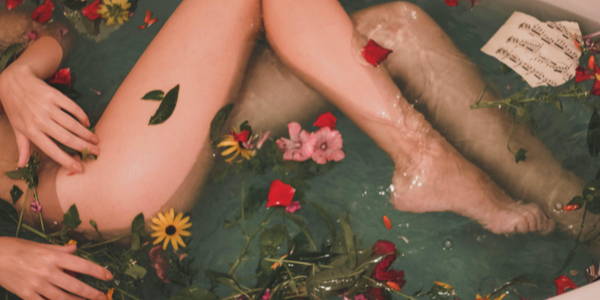 Person in bath filled with flowers